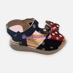 Sandalias Baby Lu negras de Minnie Mouse para niña con lunares blancos y lazo rojo brillante