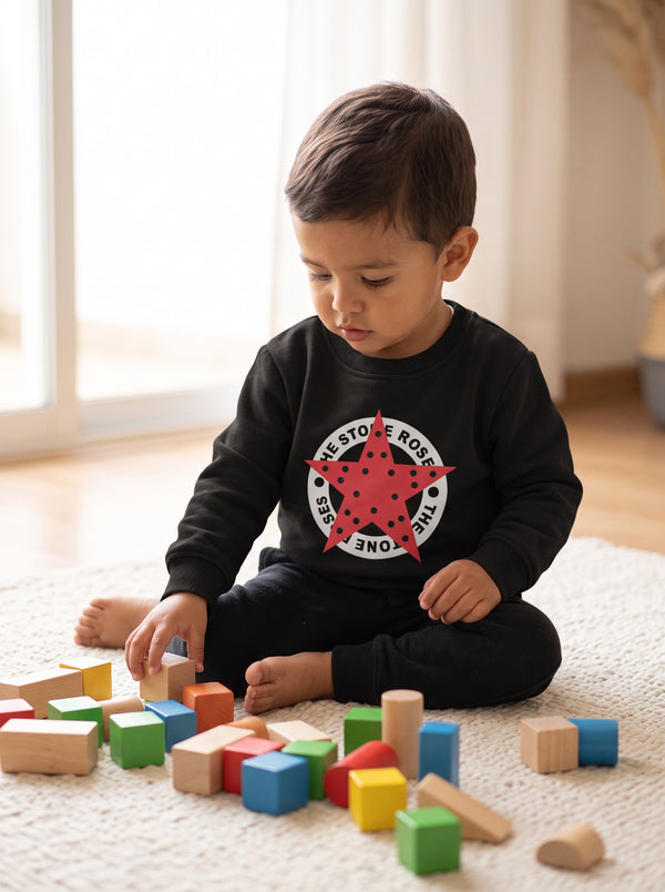 lifestyle: A new photorealistic photograph. A brightly lit, cozy living room features a soft, light cream-colored woven rug covering a light wood floor. Soft diffused light from a large window to the left gently illuminates the scene, casting subtle, inviting shadows. Colorful wooden building blocks are scattered on the rug in front of a young Latino/Hispanic toddler, approximately 2-3 years old. The toddler is seated on the rug, facing slightly away from the camera, engrossed in playing with the blocks. T…